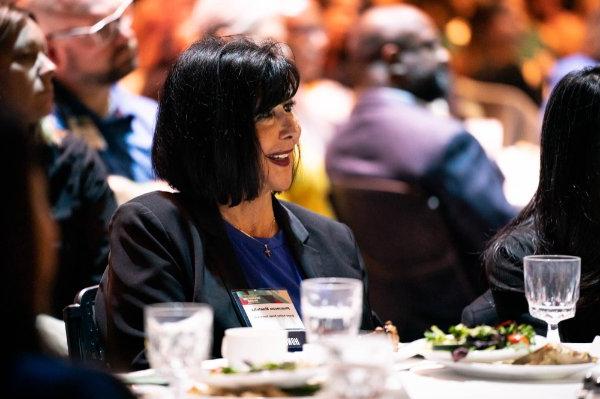 President Philomena V. Mantella listens to a speaker at the 50 Most Influential Women event in Grand Rapids.