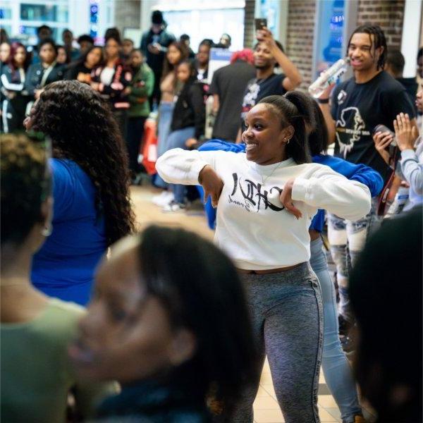A group of 学生s dances during Grand Valley's "The Blackout: Black Student Organization Showcase".